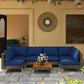 Outdoor wicker sectional sofa set with blue cushions and square acacia-style coffee table