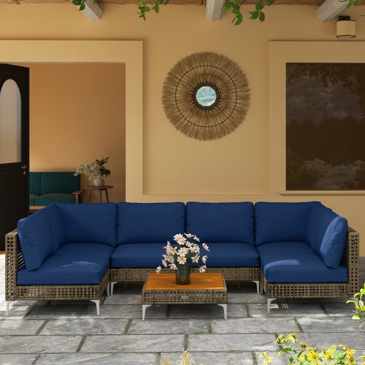 Outdoor wicker sectional sofa set with blue cushions and square acacia-style coffee table