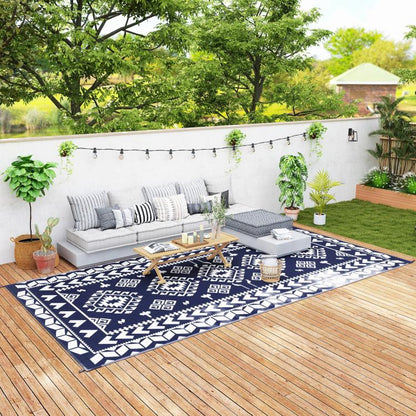 Outdoor reversible rug with blue-and-white geometric pattern and border