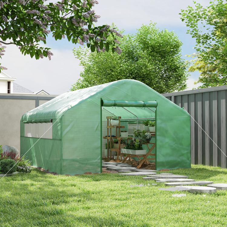 Green tunnel greenhouse hoop house with front entrance door in backyard