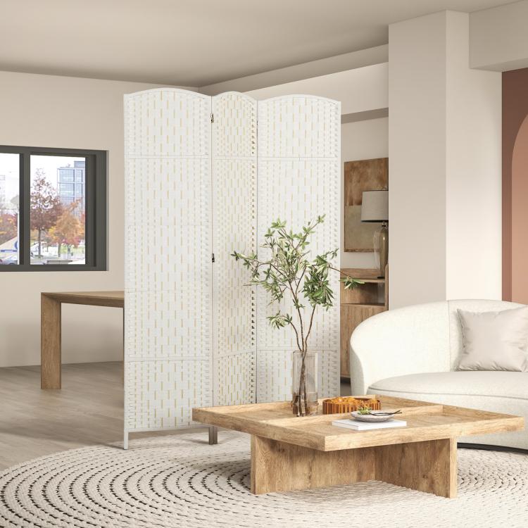 White woven 3-panel folding privacy screen standing between sofa and coffee table
