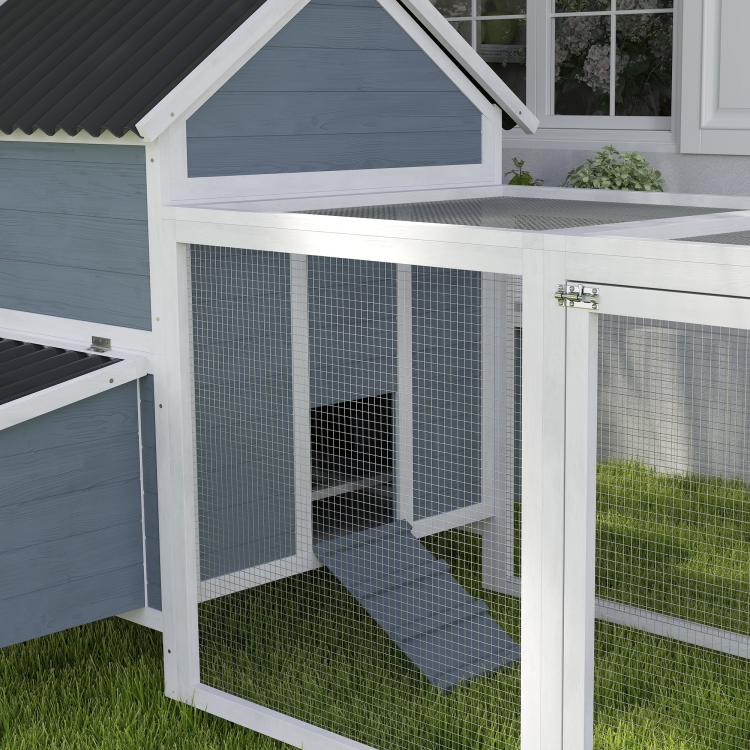Light gray wooden chicken coop with mesh run and slanted wave roof