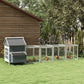 Light gray chicken coop and outdoor run with side nesting boxes under a dark roof
