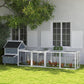 Light gray wooden chicken coop with long enclosed run and multiple nesting box openings