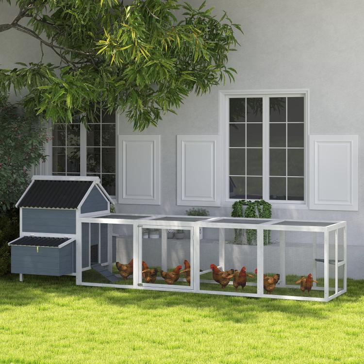 Light gray wooden chicken coop with long enclosed run and multiple nesting box openings