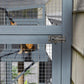 Outdoor window cat enclosure with wire mesh and scratching post, gray frame