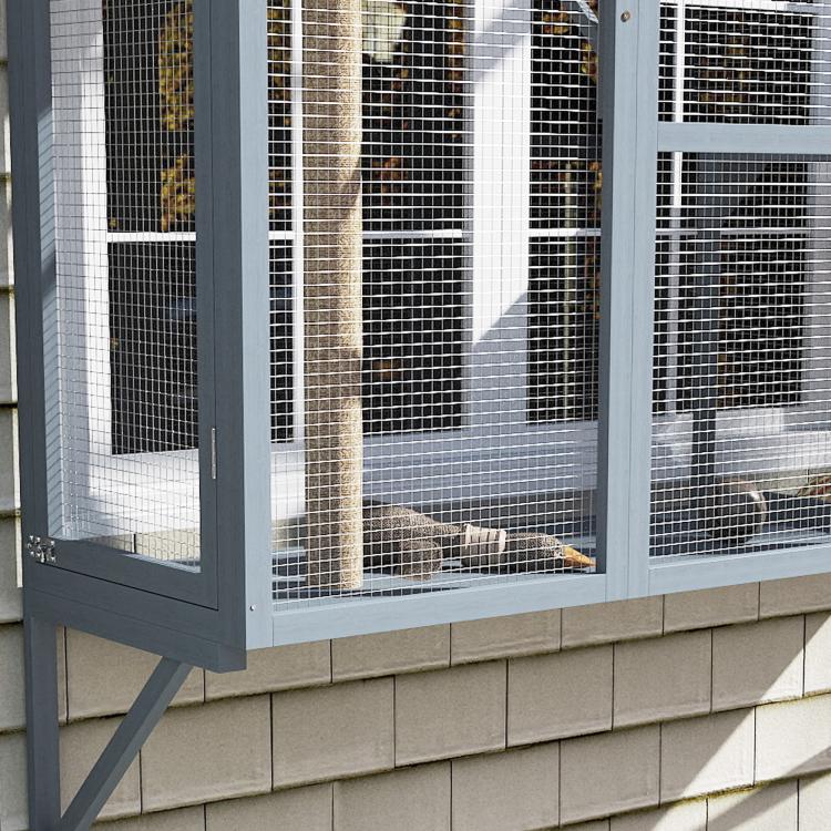 Gray window catio door with mesh panels, showing cats resting inside