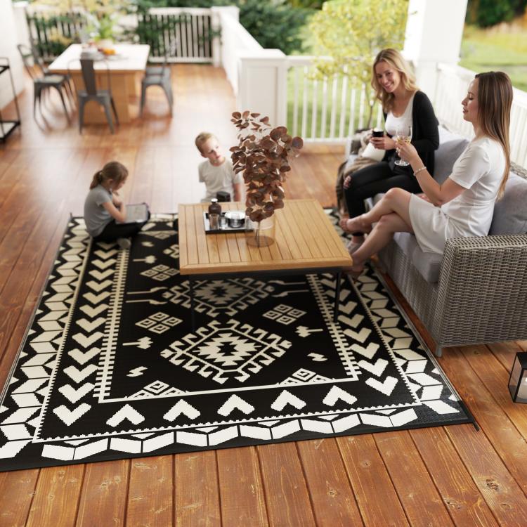 Black and white geometric outdoor rug with diamond and zigzag patchwork pattern