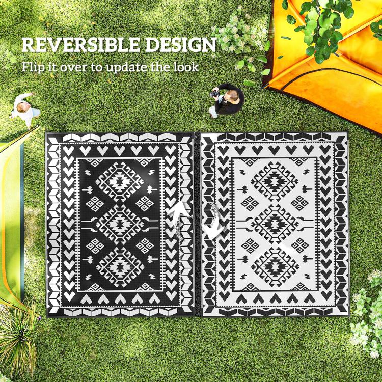 Reversible outdoor rug with two black-and-white patterned sides