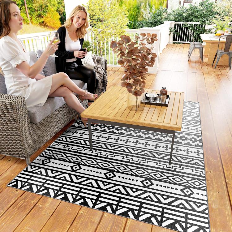 Black and white geometric outdoor rug with reversible woven pattern