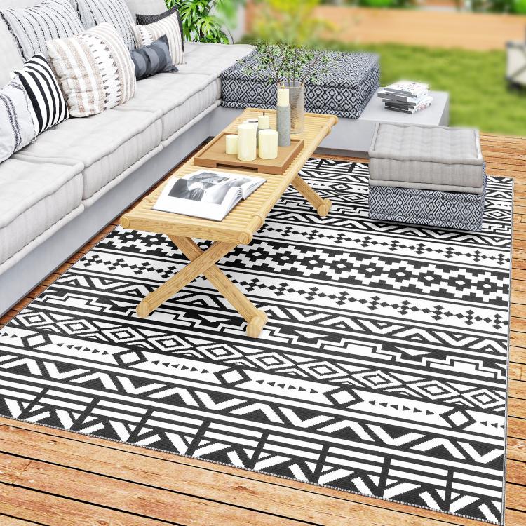 Black-and-white geometric outdoor rug with border and zigzag motif