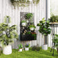 Black wall-mounted metal planter box with decorative privacy screen and green plants