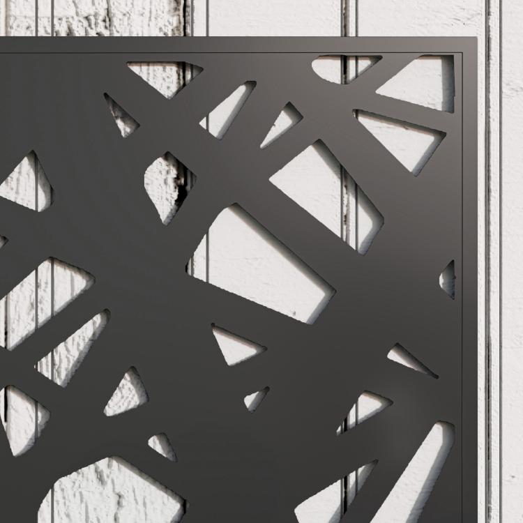 Close-up of black decorative metal privacy screen with geometric cutouts