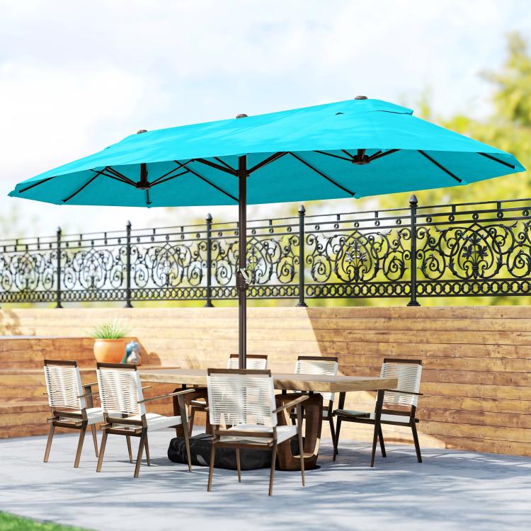 Blue patio market umbrella with outdoor dining table and chairs underneath