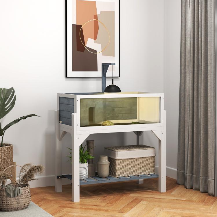 Gray wooden tortoise enclosure with clear windows, open top, and lower storage shelf in a room
