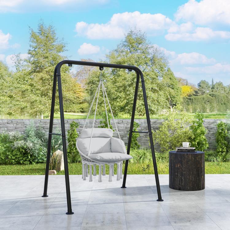 Gray hanging hammock chair on black steel stand with padded cushion and rope tassels