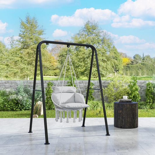 Gray hanging hammock chair on black steel stand with padded cushion and rope tassels