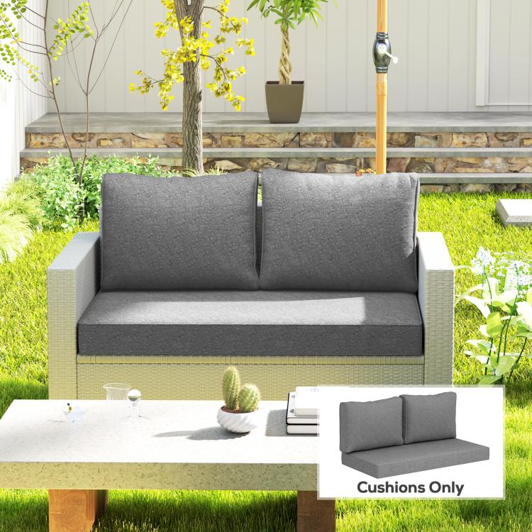 Gray outdoor loveseat cushions on a patio bench, two back cushions included