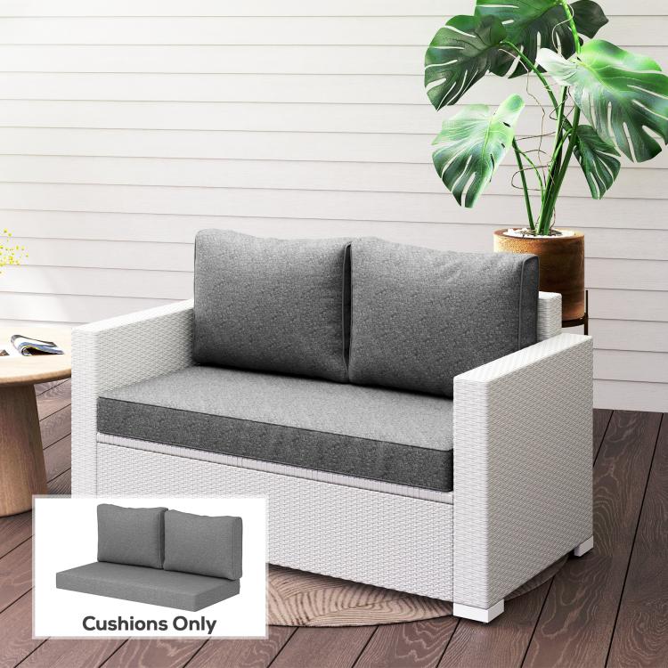 Gray patio loveseat cushion set with two back cushions and a thick seat pad