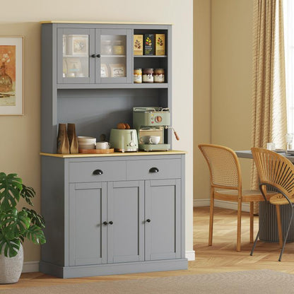 Gray freestanding kitchen pantry cabinet with glass doors, open middle shelf, and lower drawers