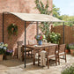 Outdoor gazebo over patio seating with cream white canopy and black support posts
