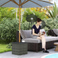 Mixed-gray outdoor side table with woven wicker sides and dark tabletop.