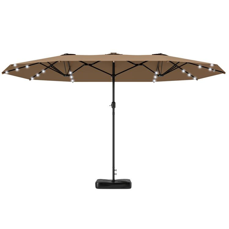 Khaki double-sided patio umbrella open over base with solar LED light bulbs