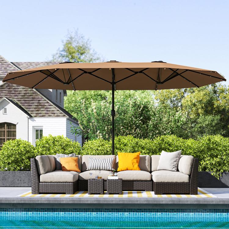 Large khaki patio parasol with open canopy and central support pole over outdoor seating