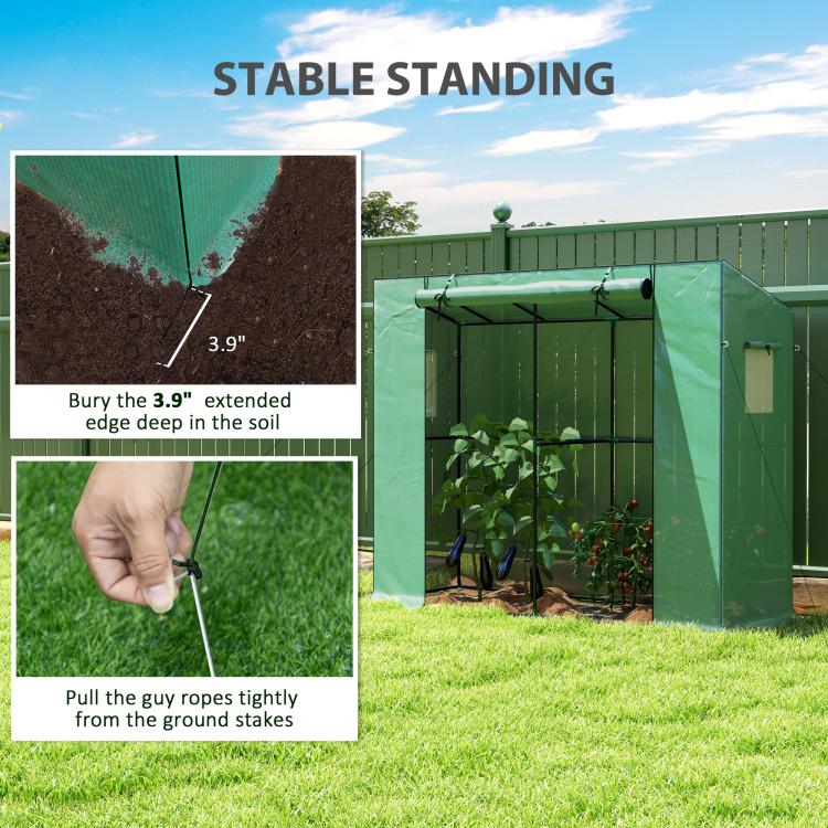 Green portable greenhouse anchored at the bottom edge with extended soil flap