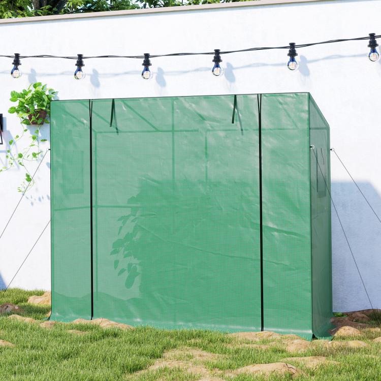 Green portable greenhouse with closed side panels and zippered front access door