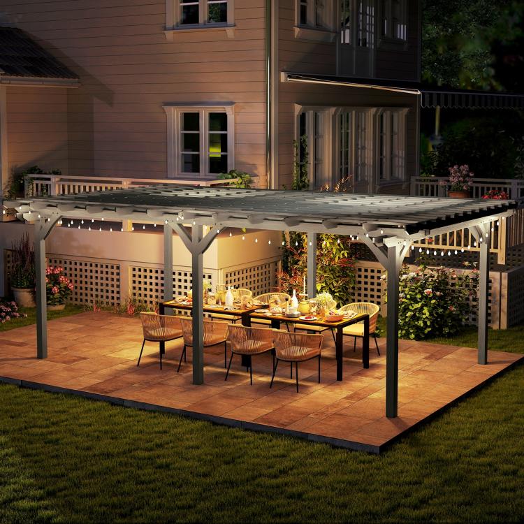 Gray outdoor pergola with slatted roof over dining set at night