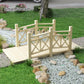 Light wood garden footbridge with lattice railings and slatted deck