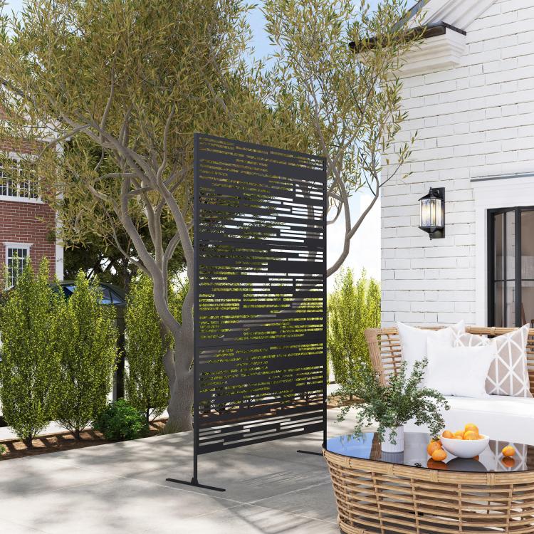 Freestanding black metal privacy screen with horizontal cutout slat pattern