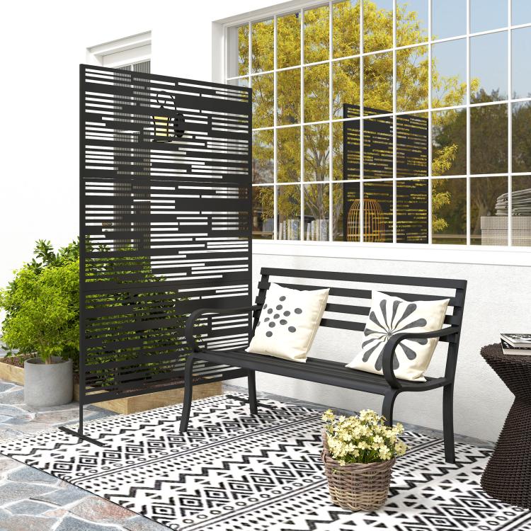 Black metal privacy screen with layered horizontal stripe design, freestanding