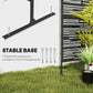 Black metal privacy screen with stable base feet and geometric slat pattern