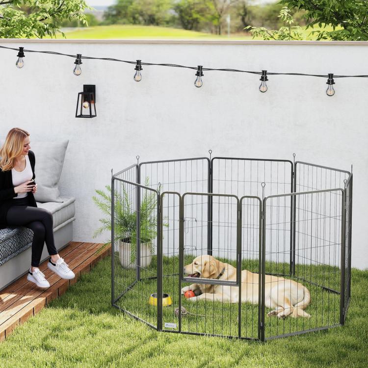 Black metal dog playpen with 8 panels, arched top, dog resting inside