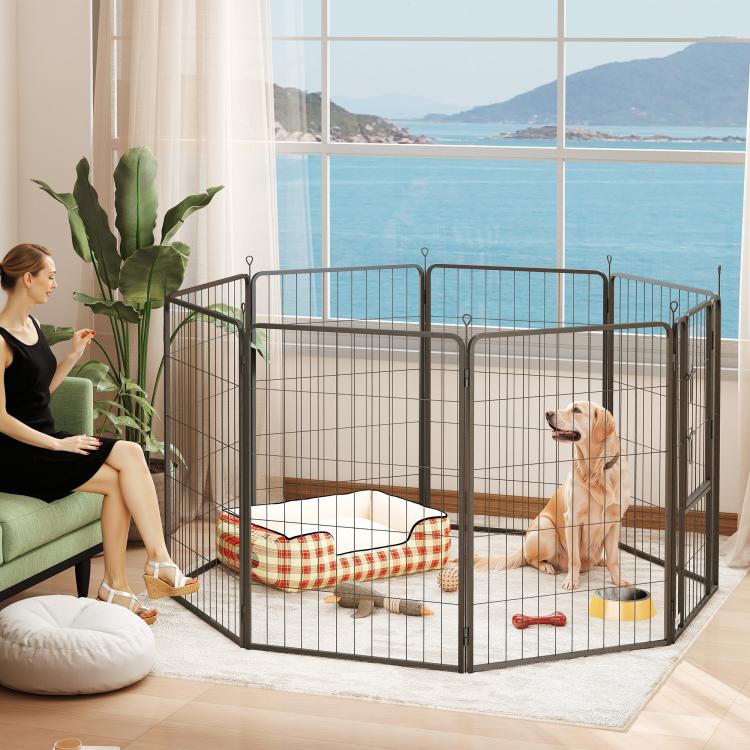 Black 8-panel metal dog playpen indoors, arched top, dog lying inside