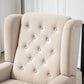 Beige wingback accent chair with button-tufted back and rounded armrests, fabric upholstery