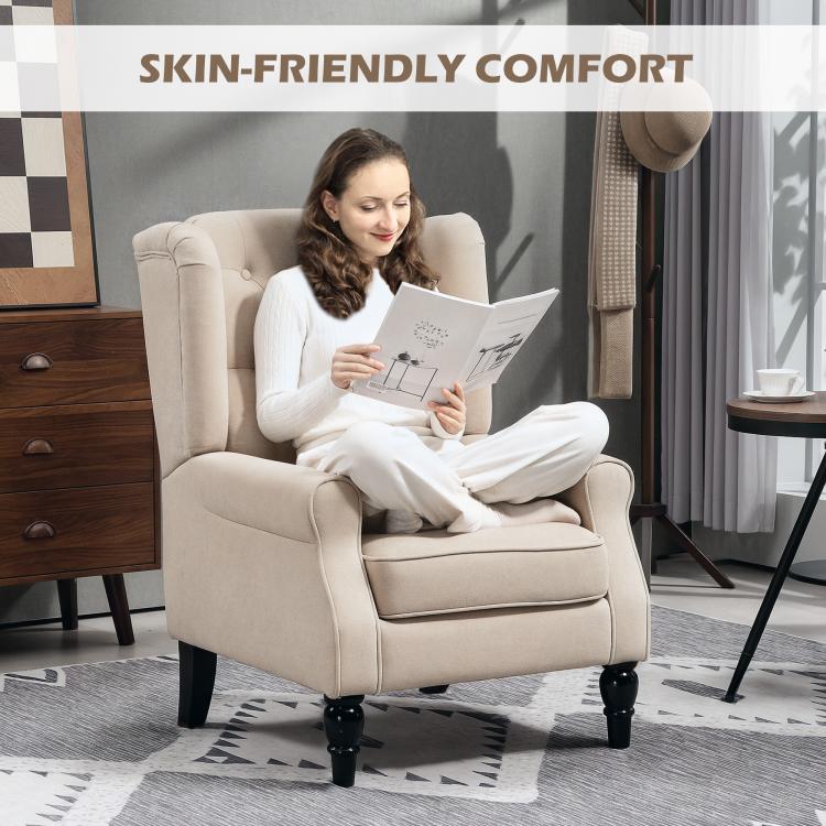 Beige wingback chair with button-tufted back and rolled arms on dark turned legs