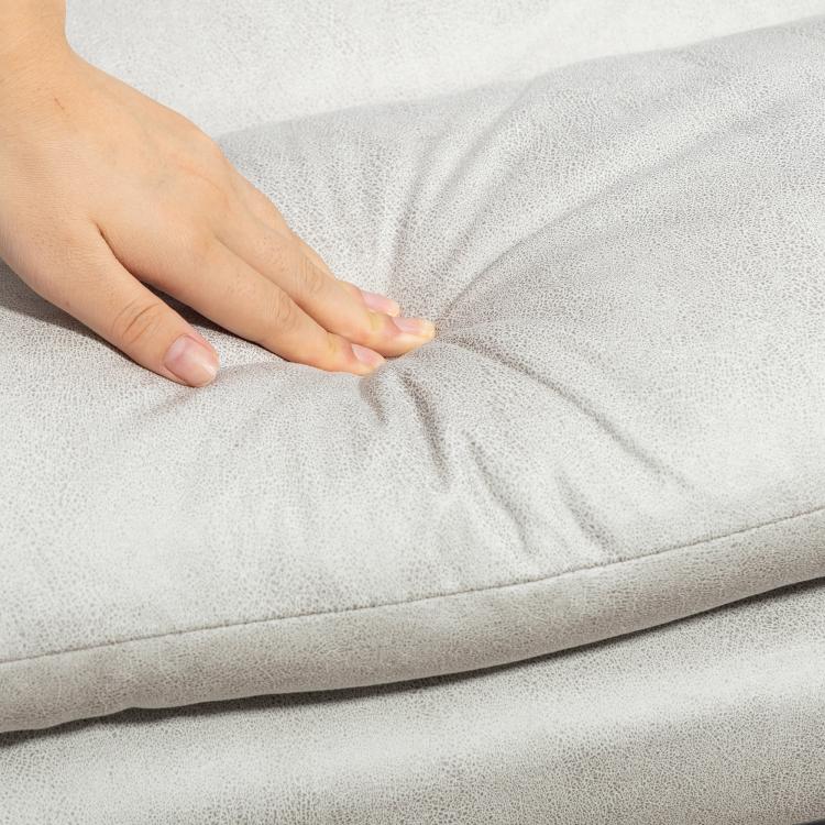 Light gray microfibre massage chair upholstery detail with hand-touching cushion