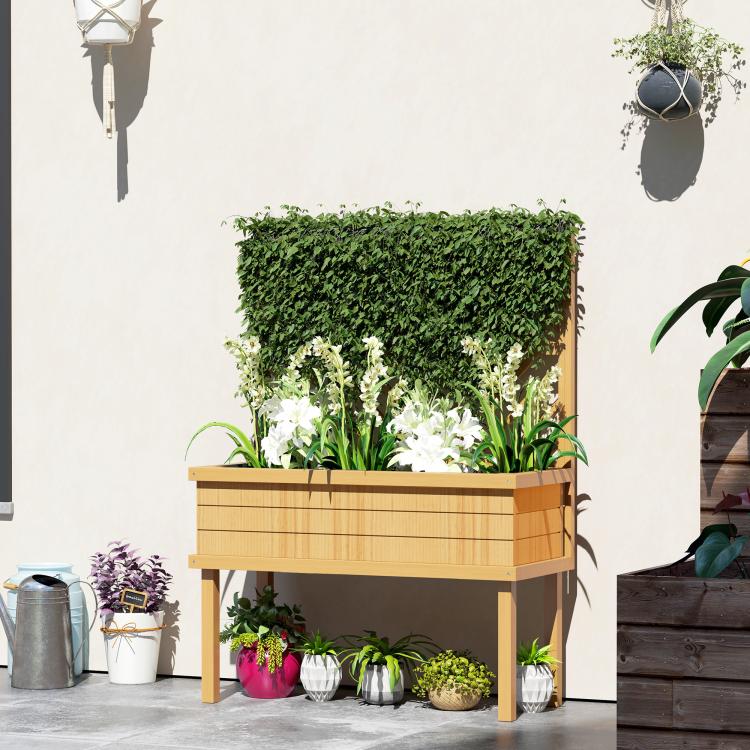 Raised wood planter bed with trellis, filled with mixed green plants