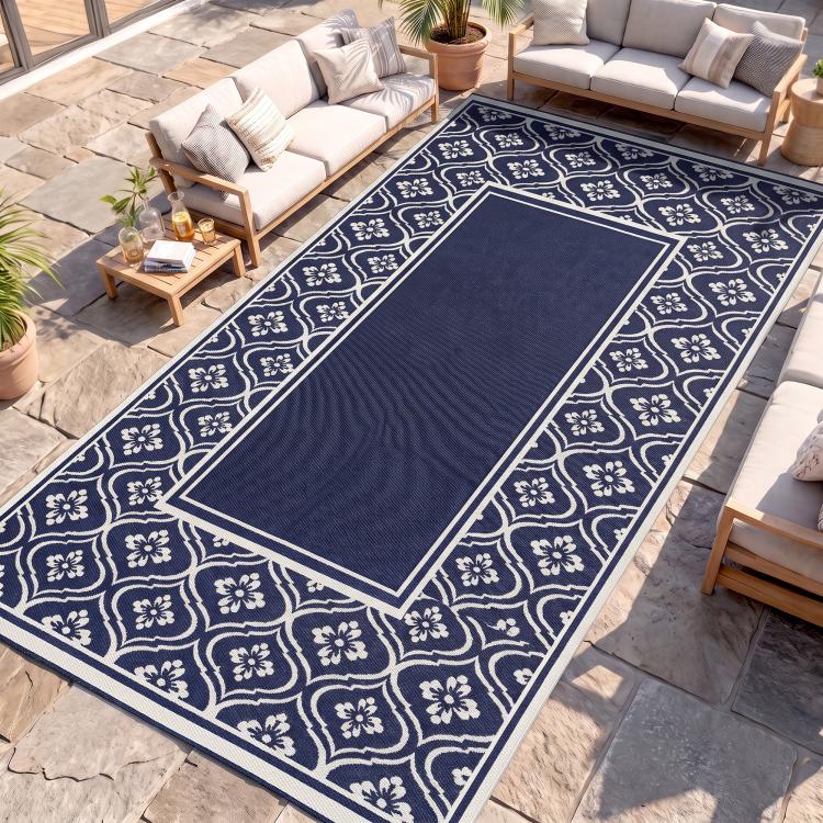 Blue-and-white outdoor rug with central navy panel and floral gourd border