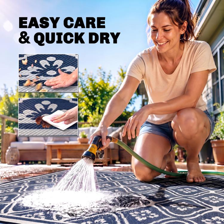 Outdoor rug being rinsed with water; navy-and-white gourd border visible