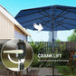 Blue patio parasol with crank lift mechanism at the center pole, close-up