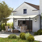 Cream white pergola canopy over patio seating with black metal support posts