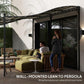 Cream white pergola canopy wall-mounted over outdoor conversation area with black frame
