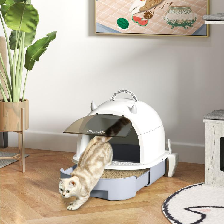 Covered cat litter box with lid and dark privacy entrance, gray base on indoor floor