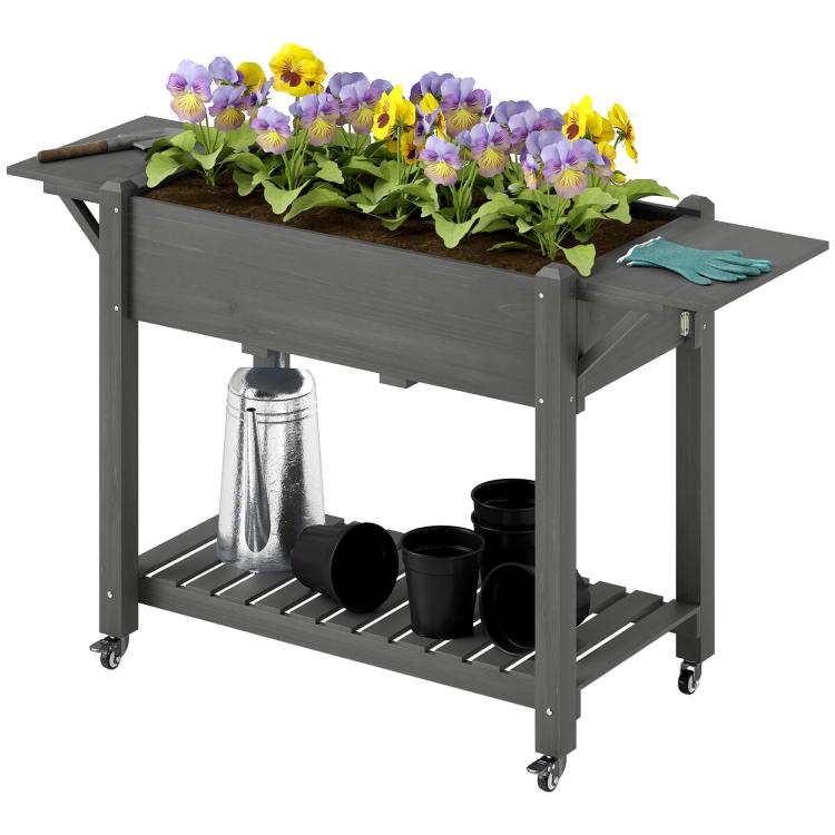 Gray elevated garden planter box with flowers, side table, and bottom shelf with pots