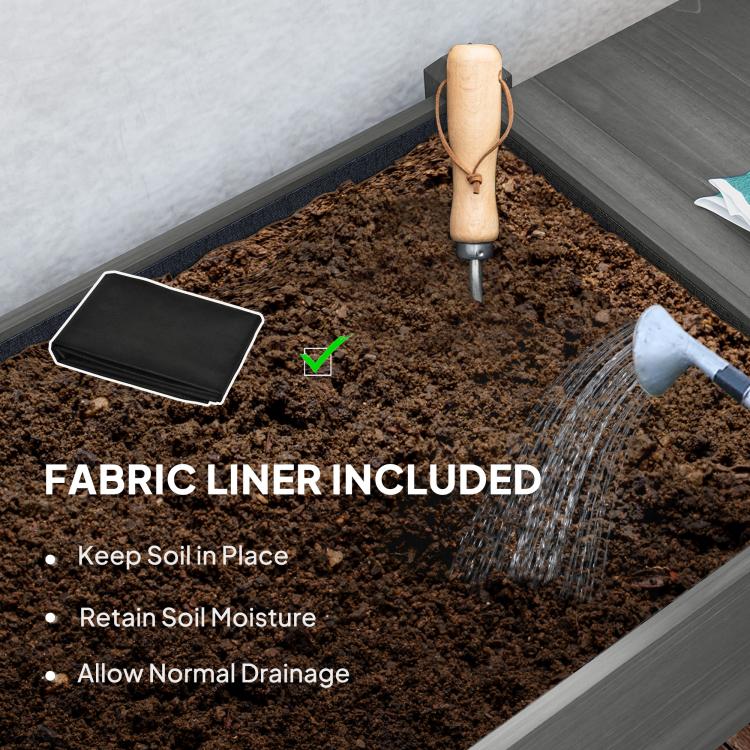 Raised planter box soil bed with black fabric liner and watering nozzle