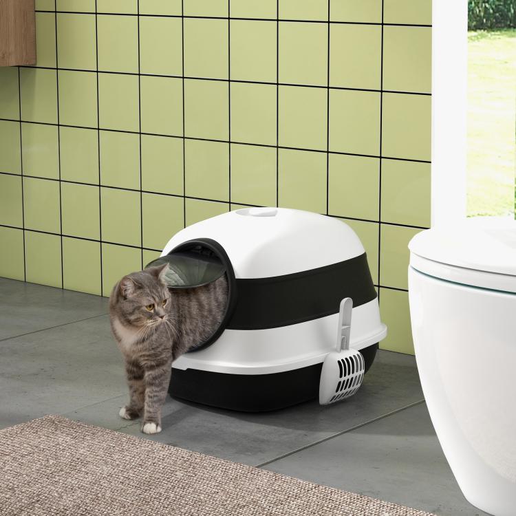 White and black covered cat litter box with open round door on side